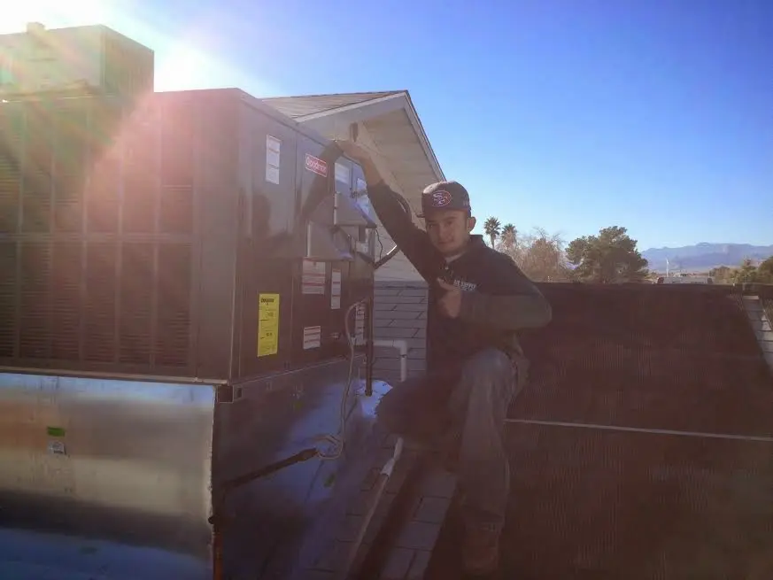 HVAC technician performing Air Duct Repair on a rooftop unit in South San Jose Hills